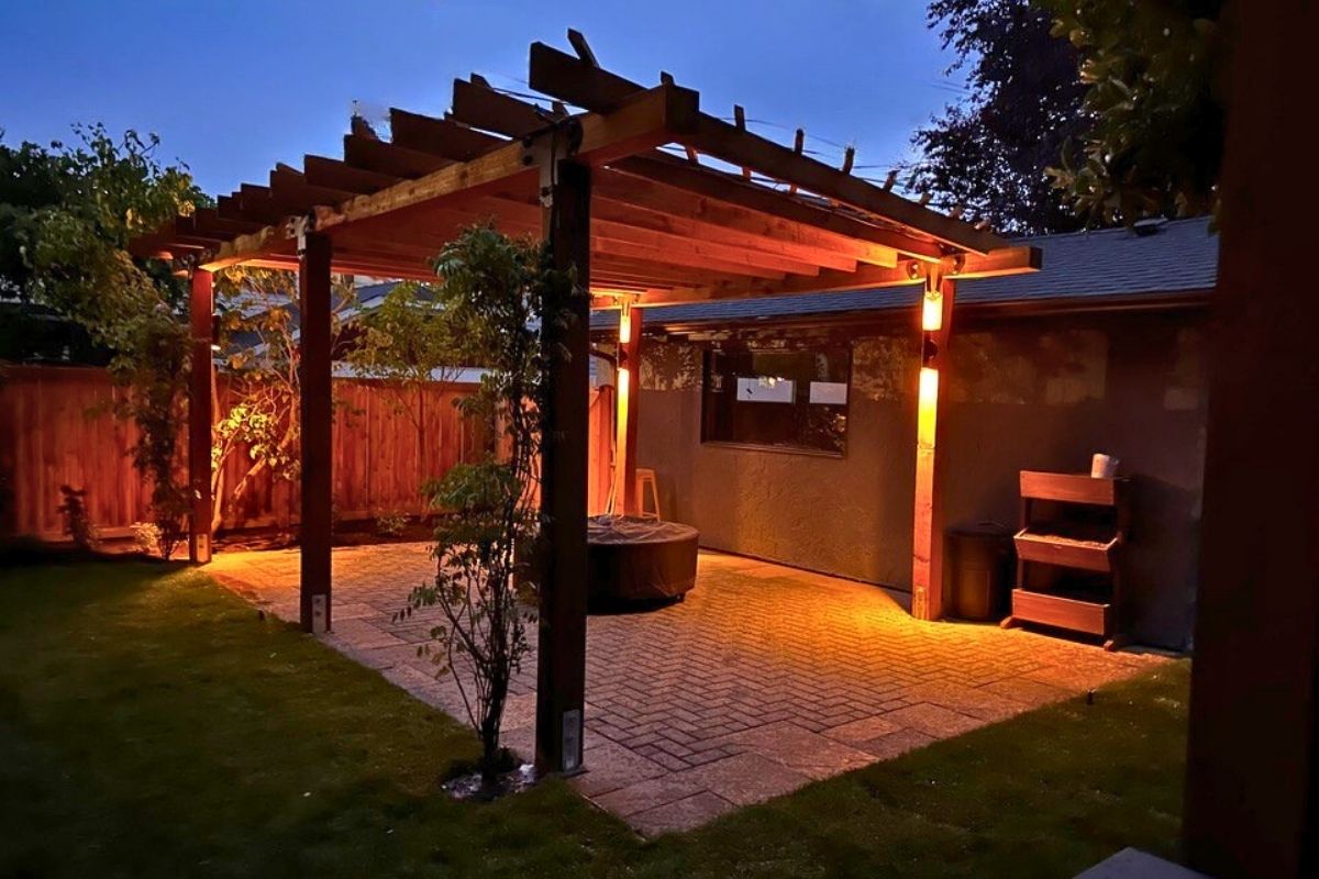 Covered patio with string lights and fire pit