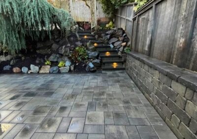 Patio, wall and stairs designed for backyard transformation