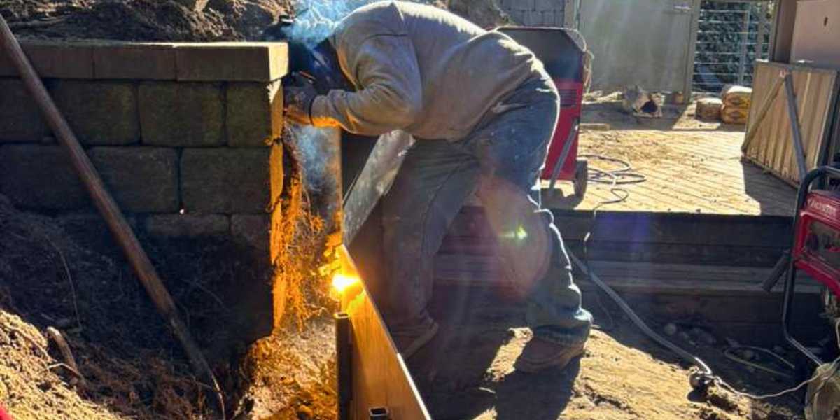 Professional crew working with metal in a landscape design installation