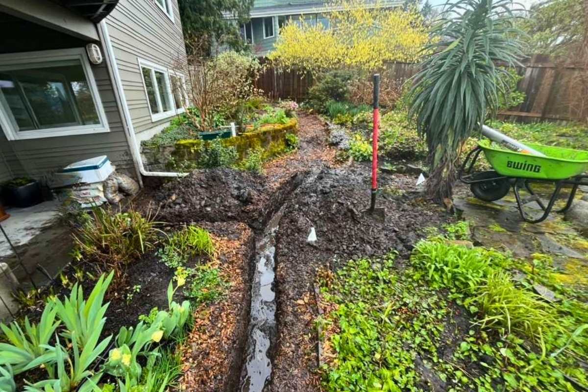 Wet landscape during drainage installation in Seattle